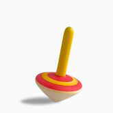 Yellow and red Colorful wooden spinning tops for kids .Handcrafted toys that inspire sensory play and motor skill development.